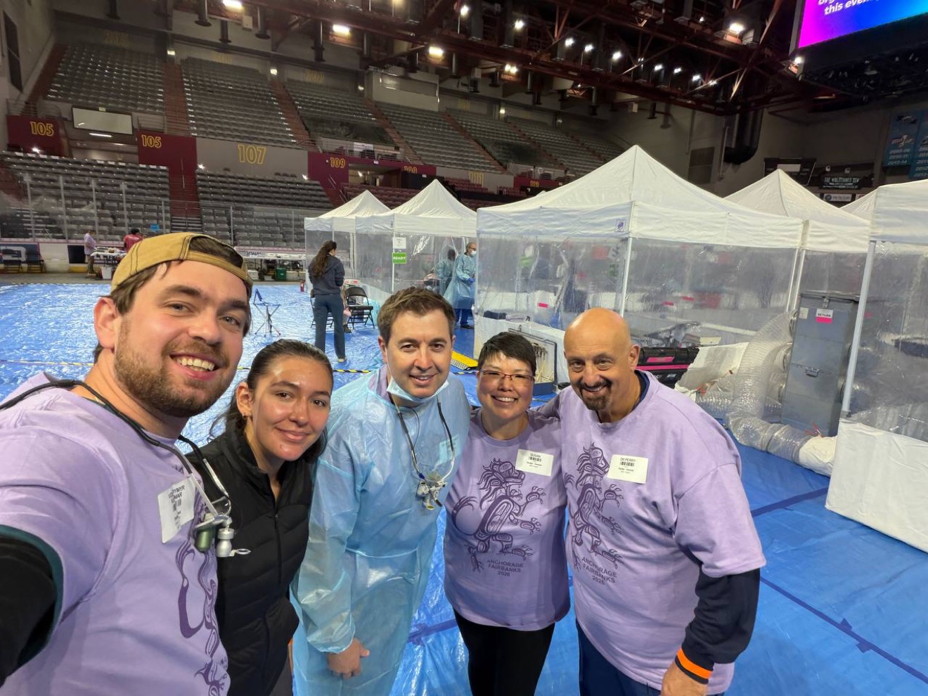 Dr. Volodymyr Kachmar with fellow volunteers inside the temporary RAM clinic in the Alaska arena.